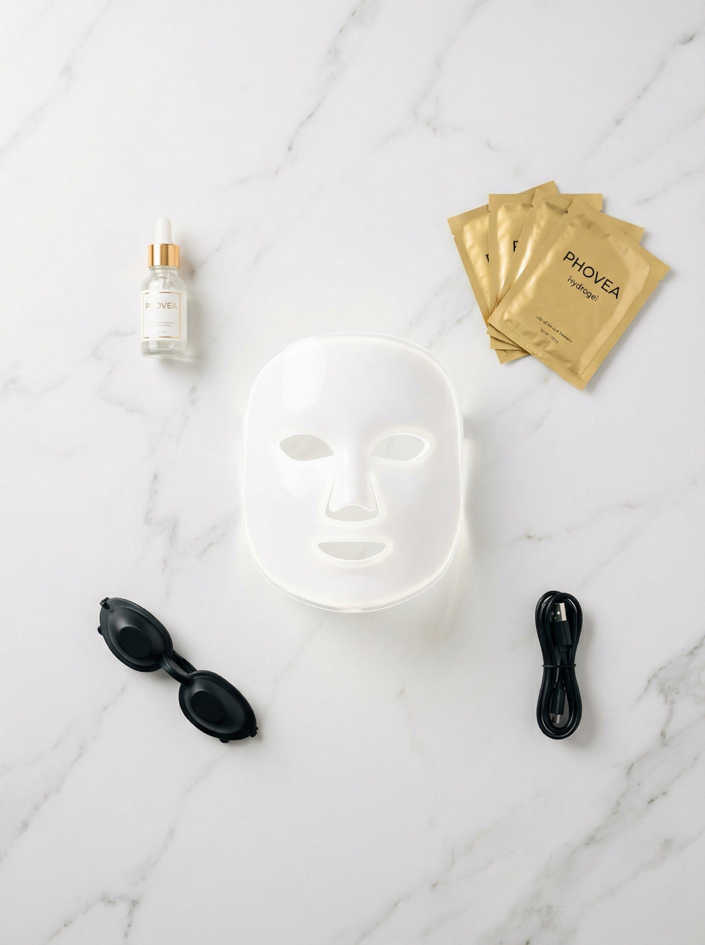 Phovea Starter Kit flat lay with LED face mask protective goggles serum and hydrogel masks